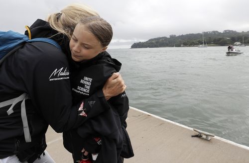 Climate activist Greta Thunberg gets a hug before she begins her voyage to the US from Plymouth on the Malizia II.
