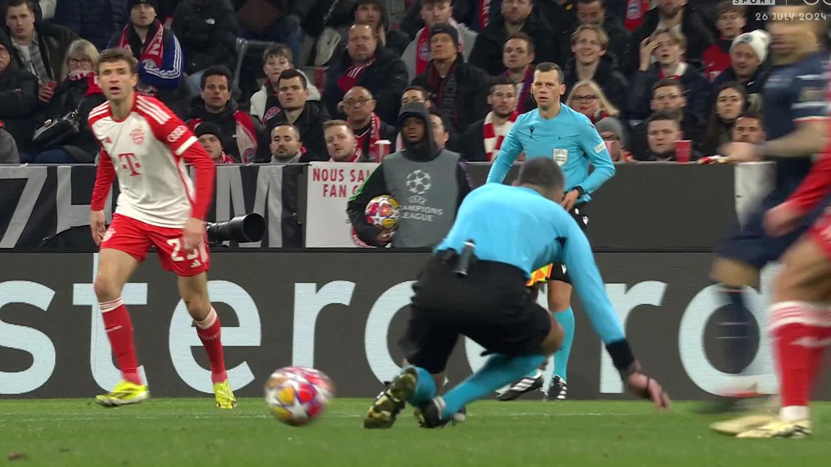 Referee Slavko Vincic slips and gets in the way of a Bayern Munich cross-field kick.