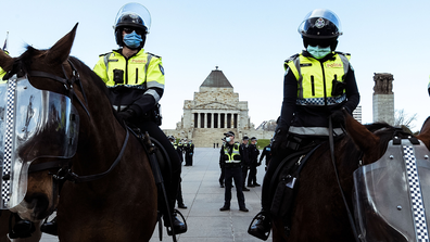Police officers stand watch as anti lockdown protesters gather at the Shrine of Remembrance on September 05, 2020 in Melbourne, Australia. 