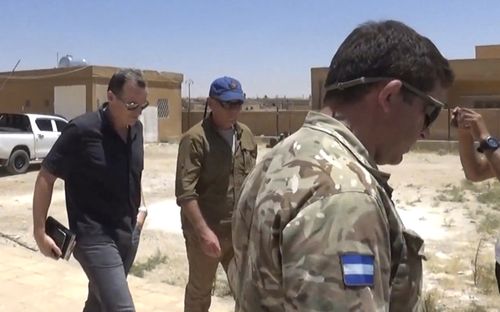 Brett McGurk (left), top US envoy for the international coalition combatting Islamic State, during a visit with local military leaders in Syria. Photo: AAP