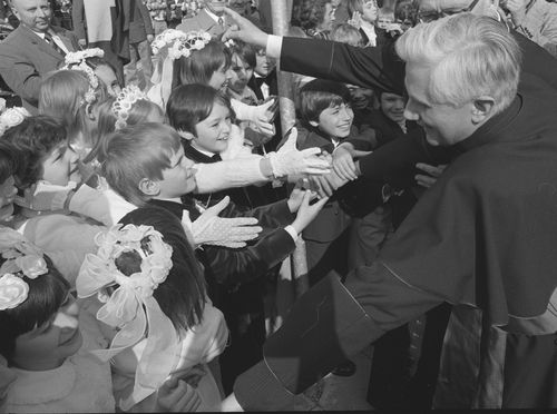 Joseph Ratzinger, archbishop of Munich and Freising, greets children in front of the Ramersdorfer Marienkirche (church of Mary) after being nominated archbishop on May 23, 1977. 
