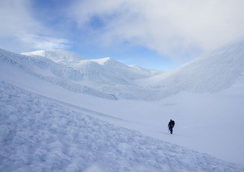 A lone figure walks through a snow covered peak on Marion Island, once of the most remote islands in the world.