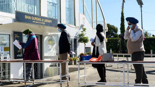 People wait for their COVID-19 vaccination at a pop-up clinic at Gurdwara Sahib Temple in Glenwood.