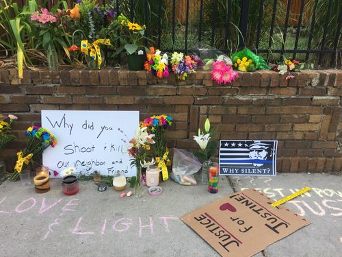 Signs and tributes on the street. (9NEWS)