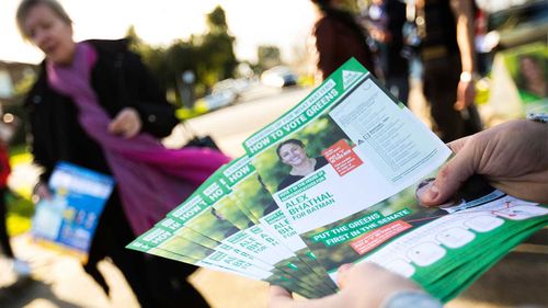 How-to-vote cards are handed out outside a polling station.