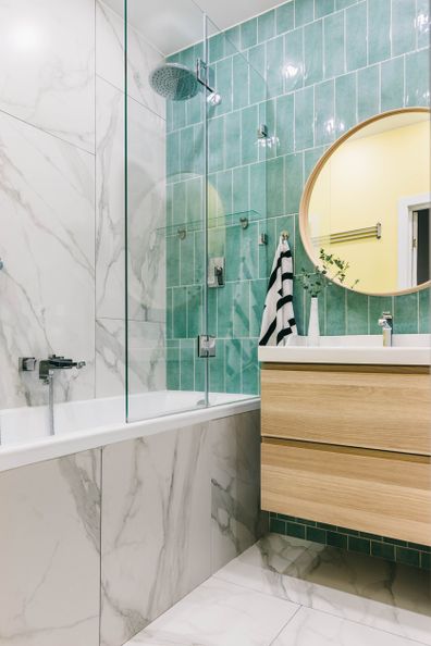 Stylish modern luxurious marble and green tiles bathroom with washbasin