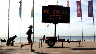 A Covid-19 public message sign at Manly Beach in Sydney, Australia, on Monday, Aug. 30, 2021. 