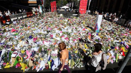 Flowers laid in memorial to the victims of the Lindt cafe siege. (AAP)