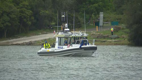 A woman has died and p﻿olice are urgently searching for two children in a south-west Sydney bay, after they were seen in distress in the water. Police were called to a boat ramp on Floyd Bay, in Lansvale after reports of a woman and two children in distress in the water.