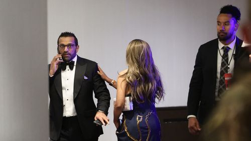 FBI director Kash Patel talks on the phone during the White House Correspondents Dinner.