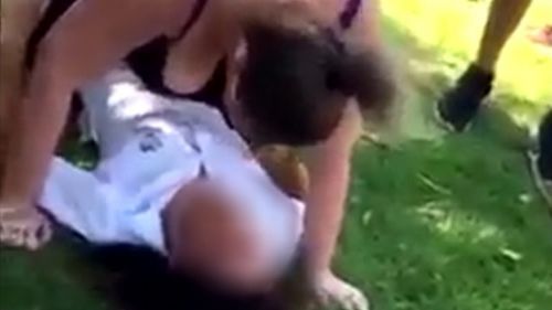 The mother is shown on video pinning the girl and screaming abuse at her before sounds of hitting are heard off-screen. (9NEWS)