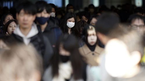 Commuters walk in a passageway during a rush hour at Shinagawa Station Wednesday, Feb. 14, 2024, in Tokyo. Japan has slipped to the worlds fourth-largest economy as government data released Thursday, Feb. 15, showed it fell behind the size of Germany's in 2023.(AP Photo/Eugene Hoshiko)