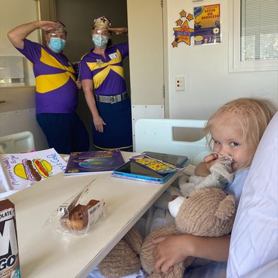 Roxy in hospital during a visit from the Starlight Captains.