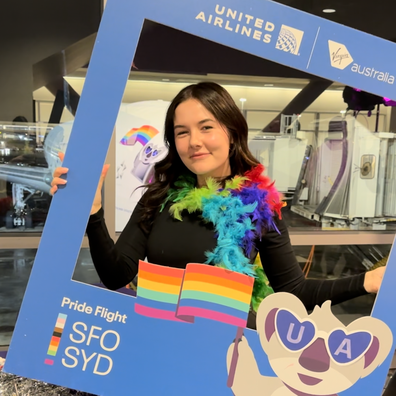 Maddison Leach poses boarding the Pride Flight from San Francisco to Sydney.