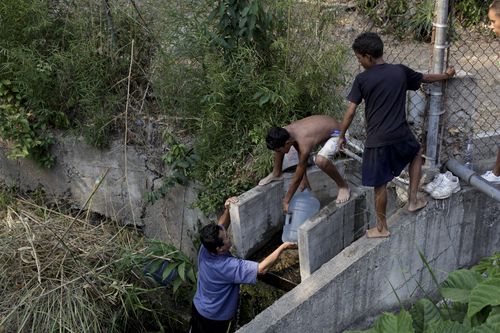 Out of desperation, people in Venezuela are even crawling into dirty canals to try and source water supplies to carry back to their homes.