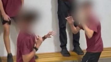 More than a dozen students at an Adelaide high school have been suspended after organising and filming a brawl at lunchtime.