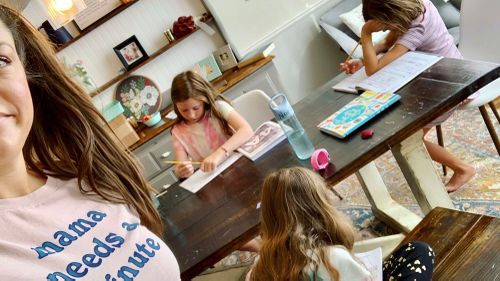 This photo provided by Amber Cessac shows Amber Cessac taking a selfie as her daughters do their homework at their home in Georgetown, Texas.