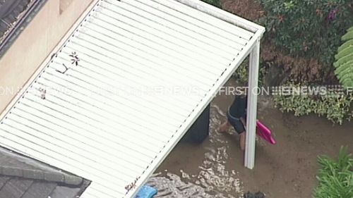At least one resident has picked up a boogie board in an effort to stop the flow. (9NEWS)