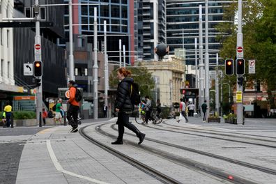 A near empty street is seen in front of Town Hall Sydney, in March. A shutdown of non-essential services is in effect Australia wide in a bid to slow the spread of the coronavirus. 