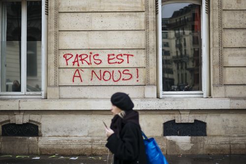 Graffiti adorns the walls of Paris, this one reading 'Paris is ours'.