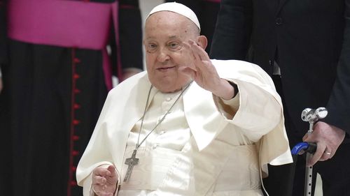 Pope Francis waves as he arrives for his weekly general audience in the Paul VI Hall, at the Vatican in February.