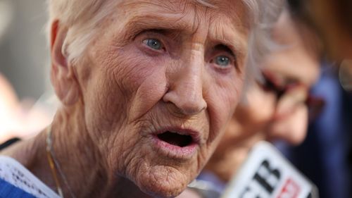 92-year-old Eileen Piper, whose daughter Stephanie killed herself after allegedly being raped by a priest, looks downwards before speaking to the media after attending the Royal Commission.