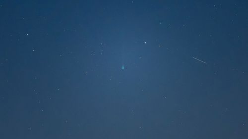 Comet Nishimura can bee seen as a faint green dot in the sky over L'Aquila, Italy, on September 7.