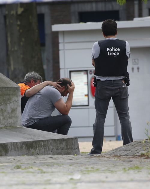 The man was comforted by officers after the shooting. Picture: AP