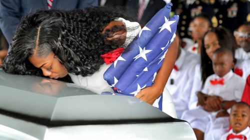 Myeshia Johnson, the wife of Army Sgt. La David Johnson, kisses her husband's casket during his funeral service last year. (AP).