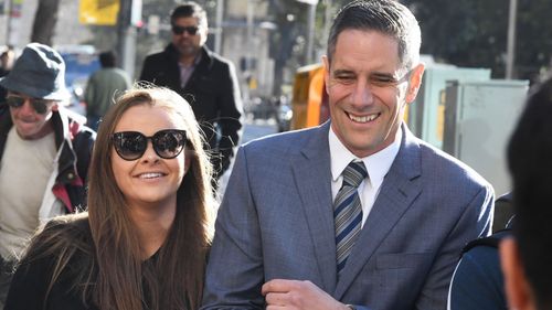 Sarah Rodgers arrives with partner, Roman Quaedvlieg, at the Downing Centre Courts, Sydney.