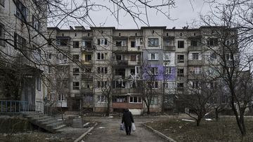 A civilian walks among heavily damaged residential buildings in Soledar, Donetsk region, Ukraine.