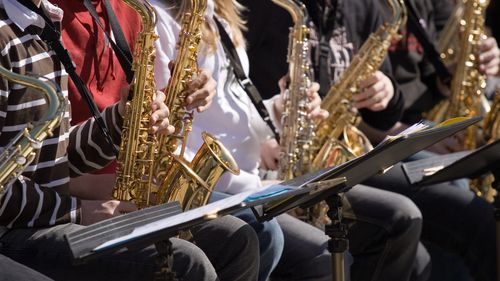 Students playing saxophone in a band.