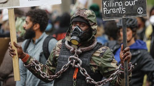 A demonstrator take part in a Black Lives Matter rally in Parliament Square in London, Saturday, June 6, 2020