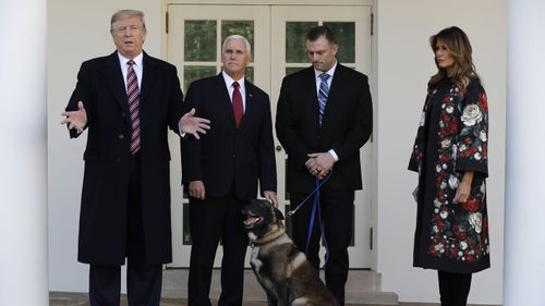 Donald Trump at the White House with Conan, the dog who chased down an ISIS leader.