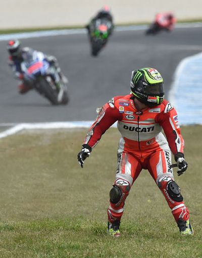 Crutchlow stands in disbelief as riders stream past. (Getty)