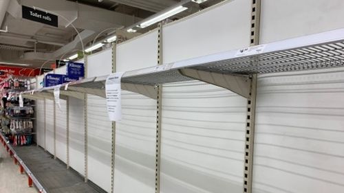 Empty shelves pictured at a Coles store as toilet paper shortages continue.