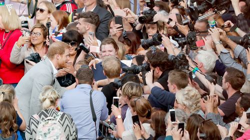 Hundreds swarm to meet Prince Harry on the eve of his wedding. Picture: AAP