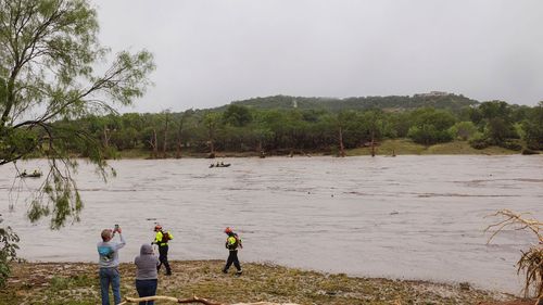 A Texas DPS helicopter conducts aerial searches along the Guadalupe River in Kerrville on July 4.