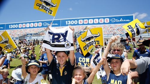 As supporters wave flags during a public Cowboys session ahead of the final, how will the weather fare? (AAP)