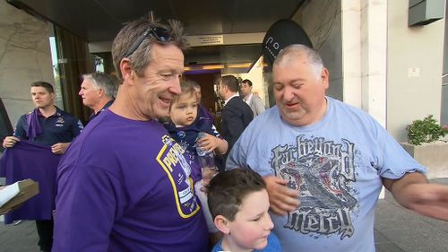 Coach Craig Bellamy with his family outside the team hotel.