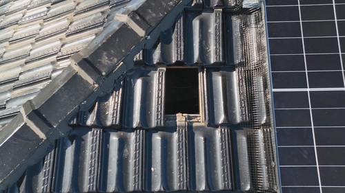 A man has been arrested after allegedly breaking a hole in an Adelaide family's roof in the early hours of the morning.