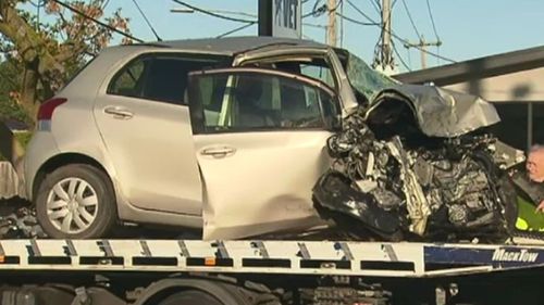 The victim's crushed car being towed from the scene last October. (9NEWS)