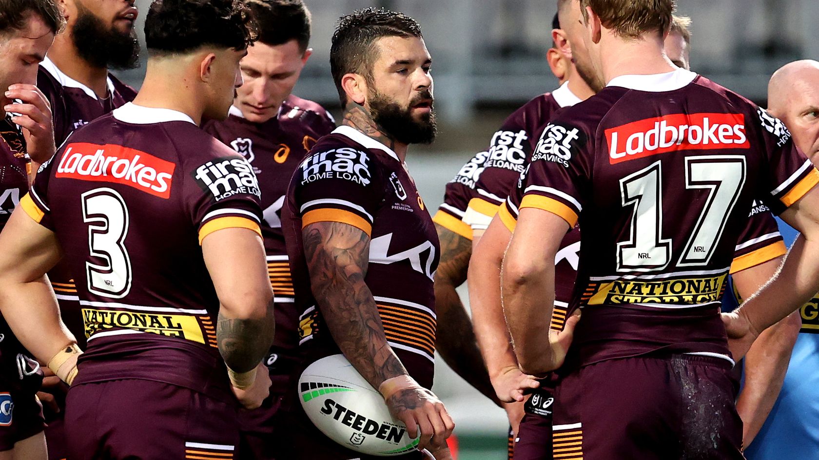 Broncos players react during their game against the Dragons.