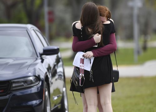 Classmates of slain student Carmen Schentrup weep after her service at St Andrews Catholic Church. (AAP)