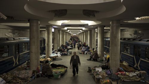 People stay in a metro station being used as a bomb shelter in Kharkiv, Ukraine.