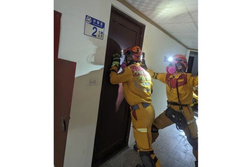 Members of a search and rescue team look for victims inside a leaning building in the aftermath of an earthquake in Hualien, eastern Taiwan on Wednesday, April 3, 2024 