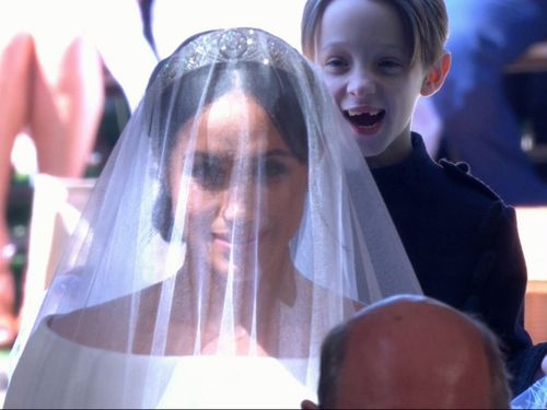 Meghan's stunning Givenchy dress turned heads when she arrived at St George's Chapel. (9NEWS)
