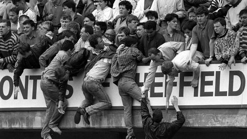 Liverpool fans trying to escape severe overcrowding during the FA Cup semi-final football match between Liverpool and Nottingham Forest at Hillsborough in 1989. Picture: AAP