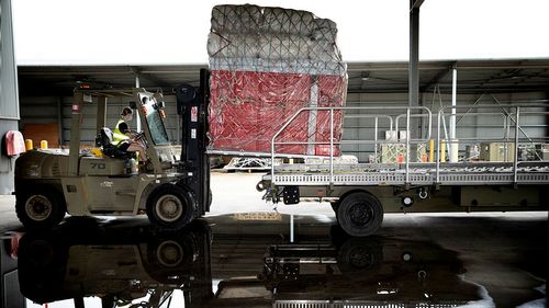 Air Force Air Movements Operators from No. 23 Squadron load pallets of humanitarian assistance supplies for rapid air movement to Tonga.