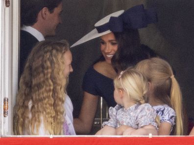 Meghan Markle with Savannah Phillips and Mia Tindall in the  Major General's office overlooking The Trooping of the Colour on Horse Guards Parade.